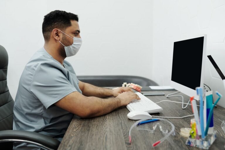 Dental office manager reviewing provider credentialing status for a new associate dentist